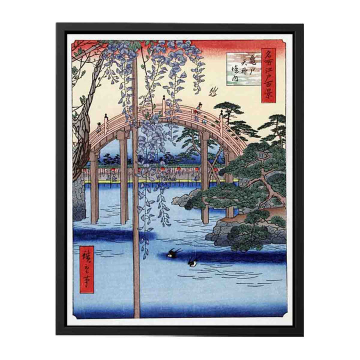 Footbridge over river with wisteria in foreground in full bloom