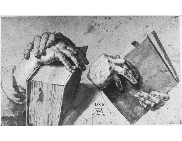 Two Hands Holding A Pair Of Books